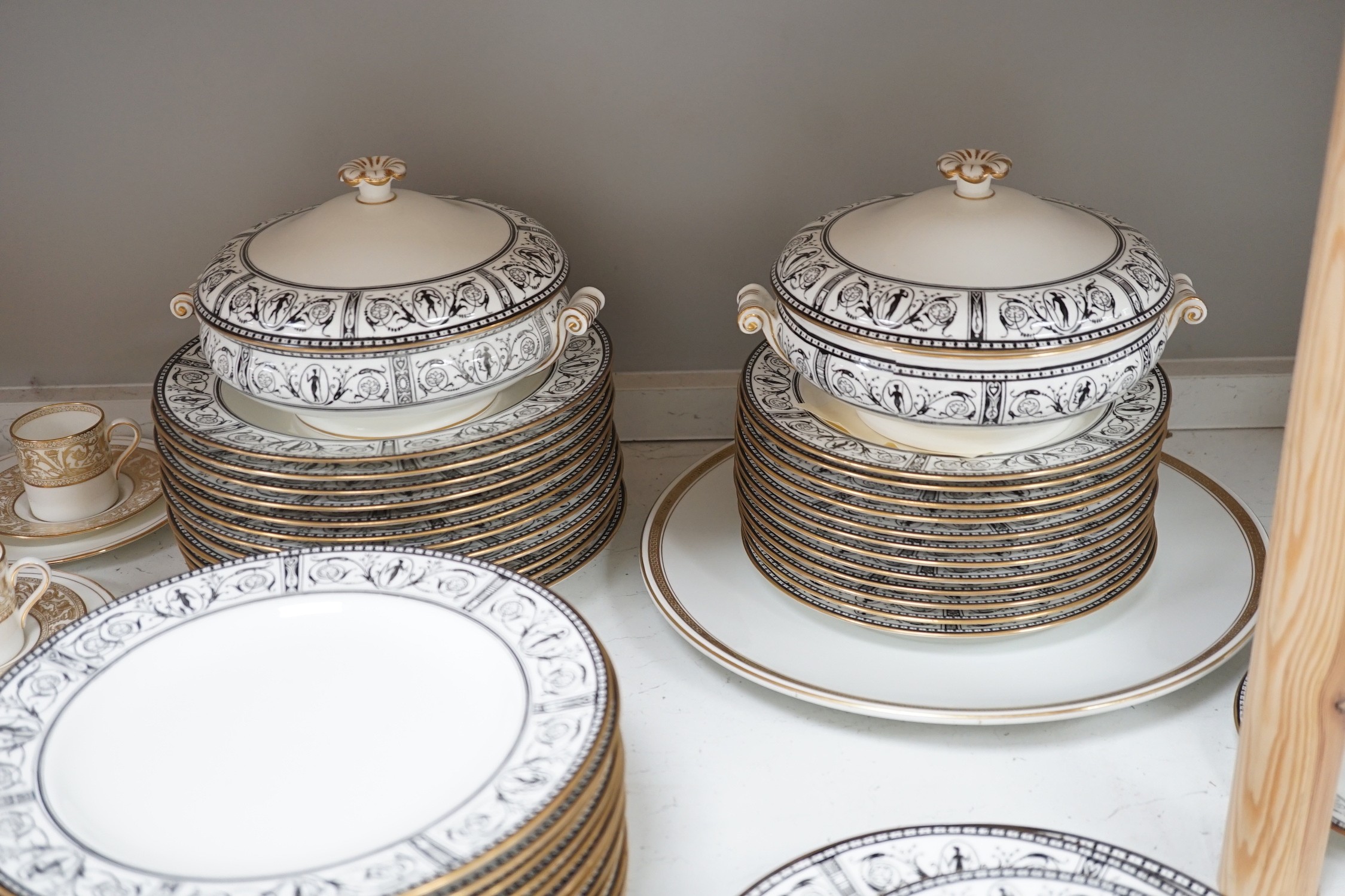 A Victorian Wedgwood part dinner service, with black printed classical borders, together with two Minton meat dishes and a Wedgwood gilt bordered coffee service.